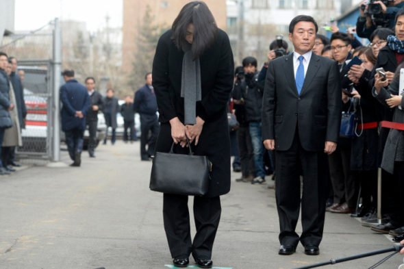 Cho Hyun-ah, daughter of chairman of Korean Air Lines, bows in front of the media outside the offices of the Aviation and Railway Accident Investigation Board in Seoul