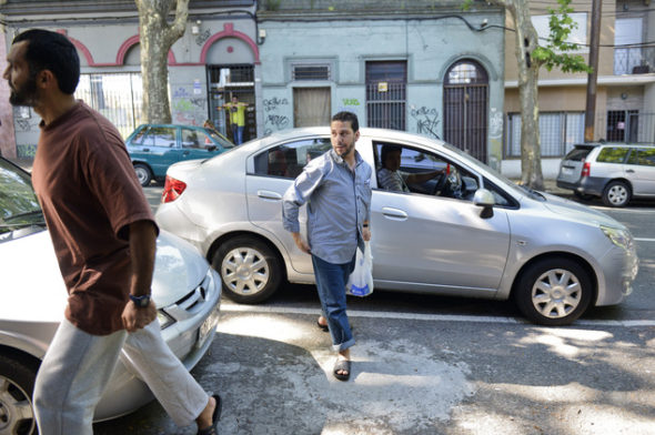Matta, left, and El Ouerghi, right, step out of a car with shopping as they explore their new home
