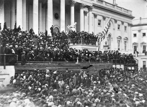 This photograph (top) of Lincoln delivering his second inaugural address is the only known photograph of the event. Lincoln stands in the center, with papers in his hand. John Wilkes Booth is visible in the photograph, in the top row right of center.