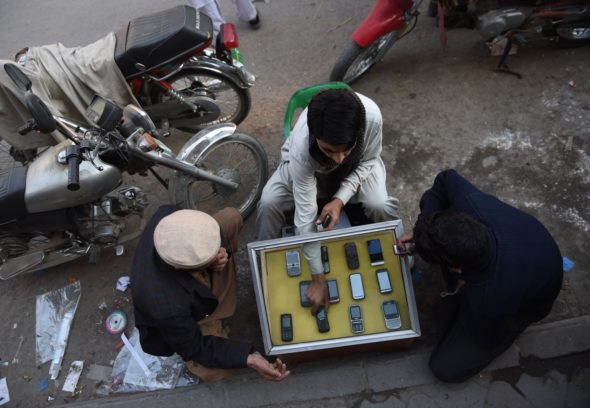 A Pakistani mobile vendor deals with customers at his roadside stall in Rawalpindi on Jan. 6. 