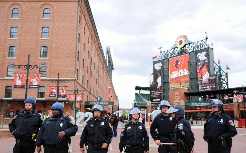 Baltimore police officers stand outside Oriole Park at Camden Yards prior to the cancellation of Monday night’s game between the Chicago White Sox and Baltimore Orioles. Tuesday’s game was also postponed. 