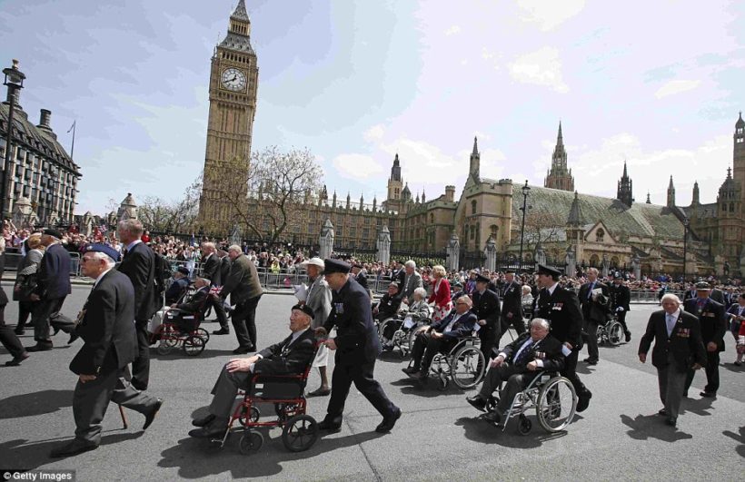 Huge crowds watched as hundreds of veterans joined the parade, with those in wheelchairs pushed by members of the armed forces