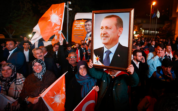 People wave flags and hold a portrait of Turkish President Tayyip Erdogan outside the AK Party headquarters in Istanbul (Photo: Reuters)