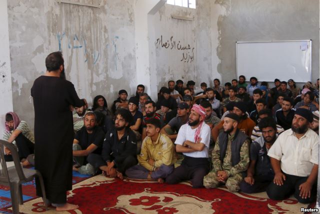 Rebel fighters from the Ahrar al-Sham Movement take Islamic and Koran lessons inside a camp, during the holy month of Ramadan in Idlib countryside, Syria, July 7, 2015. The group pulled out of a meeting of opposition groups in Saudi Arabia, Dec. 10.