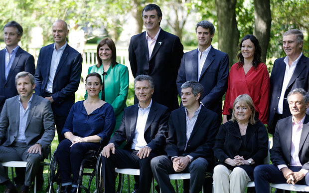 Argentina's President-elect Mauricio Macri, front third from left, sits with some members of his nominated new cabinet at the botanical gardens in Buenos Aires, Argentina
