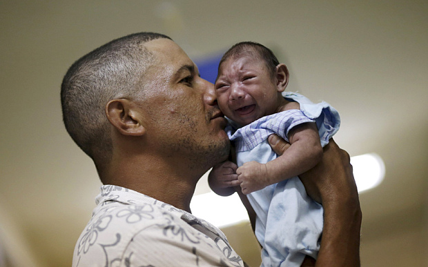 Geovane Silva holds his son Gustavo Henrique, who has microcephaly, at the Oswaldo Cruz Hospital in Recife, Brazil (Photo: Reuters/Ueslei Marcelino) 