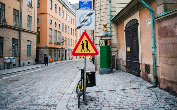 A road sign arning against pedestrians focusing on their smartphones is pictured on February 2, 2016 near the old town in Stockholm. ( AFP / Jonathan Nackstrand) 