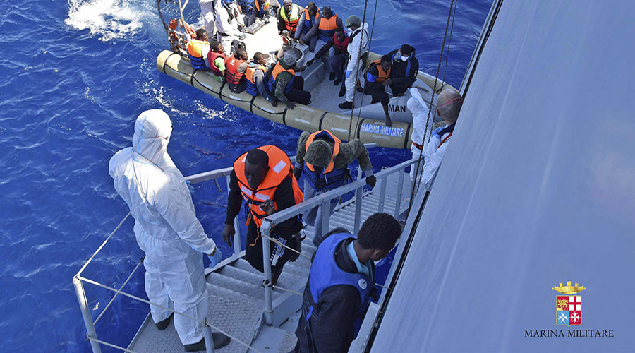 Migrants sit in a rescue boat during a rescue operation by Italian Navy vessels off the coast of Sicily in this April 11, 2016 handout picture provided by Marina Militare.
