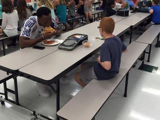 FSU receiver Travis Rudolph bites into a slice of pizza as he joins Bo Paske for lunch August 30th at Montford Middle School. (Photo: Leah Paske) 