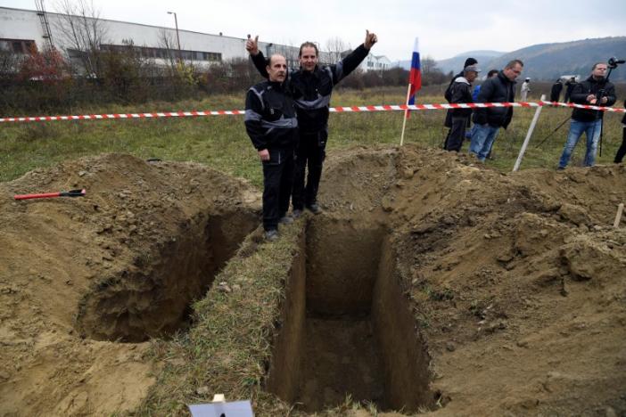 Winners, brothers Ladislav (L) and Csaba Skladan from Slovakia, pose for a photo during a grave digging championship in Trencin, Slovakia, November 10, 2016, where eleven pairs of gravediggers are competing in digging based on accuracy, speed, and aesthetic quality. (Photo: Reuters/Radovan Stoklasa) 
