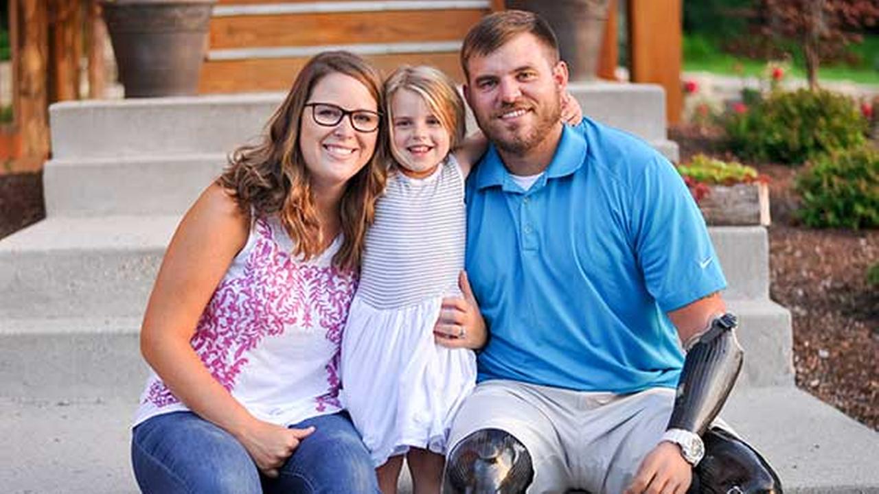 Retired U.S. Army Staff Sgt. Travis Mills is one of only five servicemen from the Iraq and Afghanistan wars to survive as a quadruple amputee. With his wife Kelsey and daughter Chloe.